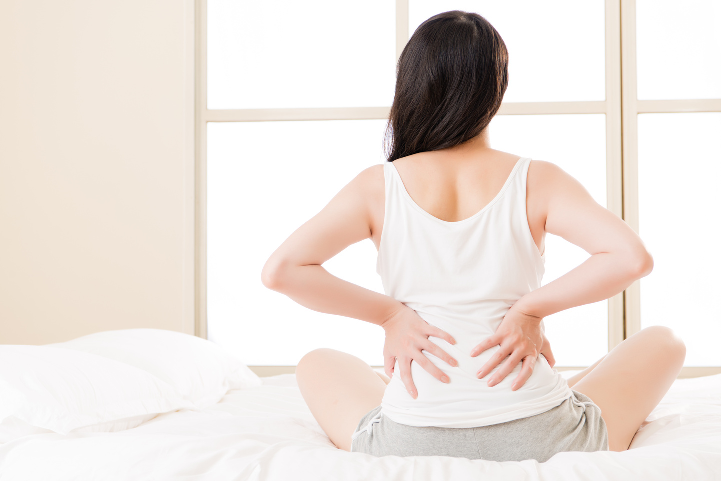asian woman suffers back pain backache, spinal lower problem